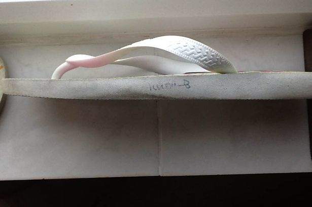 This is one of the flip flops the ship captain gave her parents. The name clearly does not say Rebecca