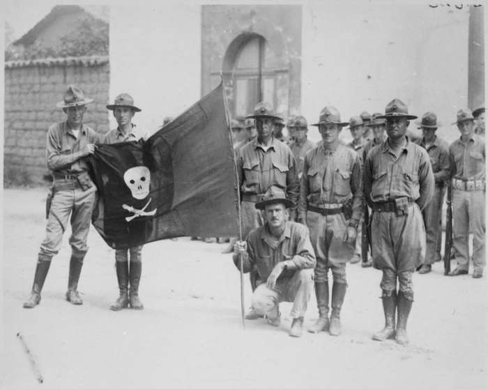 In Nicaragua 1932 U.S. Marines hold the captured flag of Nicaraguan revolutionary leader Augusto César Sandino.