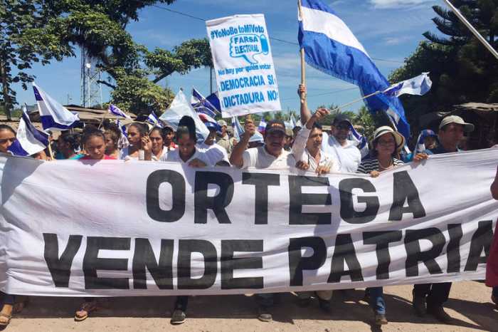 Thousands protesting Ortega during 2016 election.. Banner reads "Ortega Sells the Country"