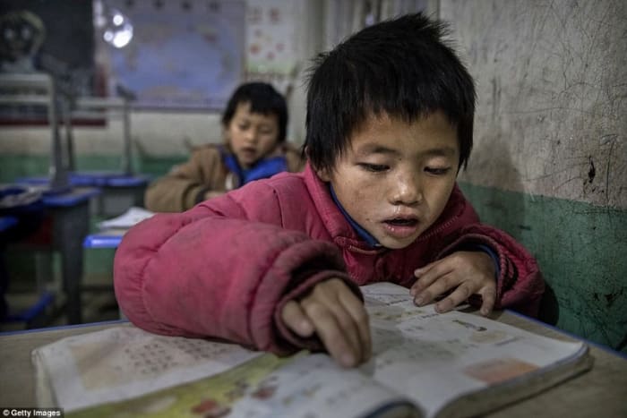 Young Luo Hongniu, aged eight, is being raised by his grandparents in the rural province of Anshun (DailyMail.com - 2017)