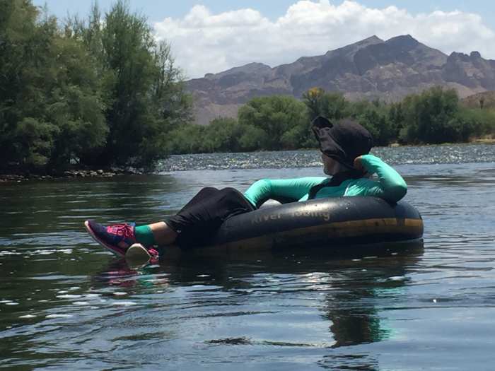 My wife escaping the July heat and enjoying the passing scenery as she floats down the Salt River in a giant inner tube.