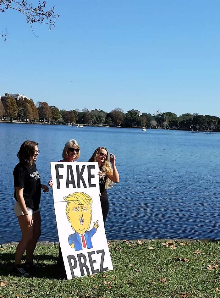 These women cleverly made their sign hinged in two places. That makes it fold into one square that's easier to carry. (photos by Virginia Allain from the Orlando Women's Rally)