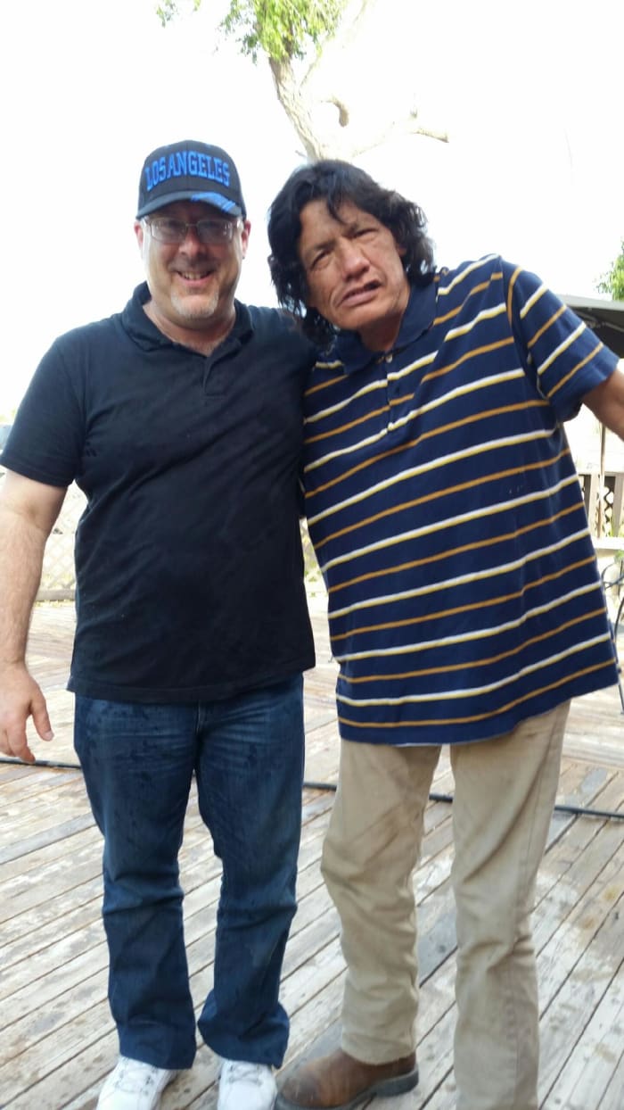 I dislike this photo. I felt sorry for the man. He had a major meth issue, as he discussed with us. This photo appears that I was having fun at his expense. I was not. I wanted to smile for respect; this was a tough shot.