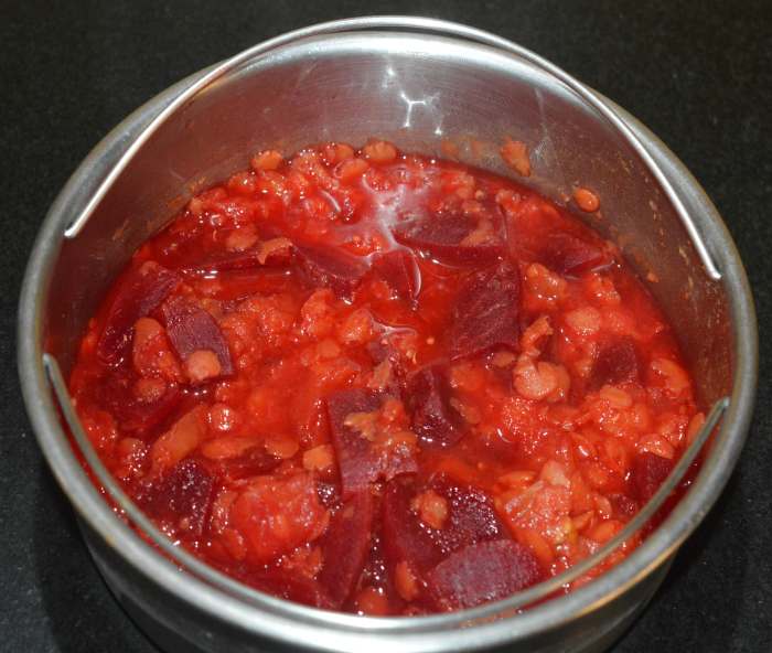 When the pressure releases naturally, take out the container. Add the cooked mixture to a mixer jar.
