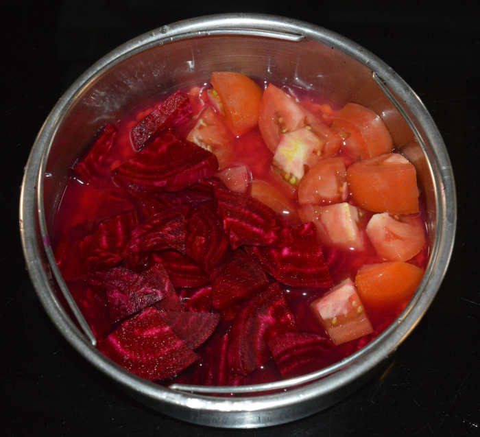 Step one: Add thinly chopped beetroot, chopped tomatoes, and washed split pigeon peas to a container. Add 1/2 cup of water. Place it in the pressure cooker. Cook it up to 4 whistles and simmer for 5 minutes. Turn off the heat.