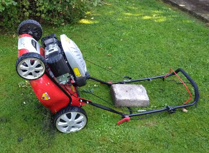 Alternatively lower the mower back onto its handles. A weight such as a block will keep it in place.