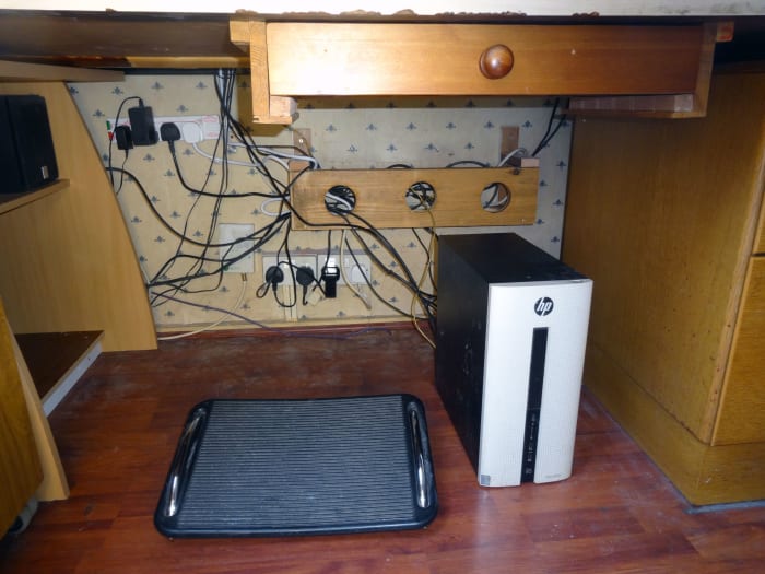 Simple bespoke cable management trough made from recycled wood, designed to keep the cables off the floor.