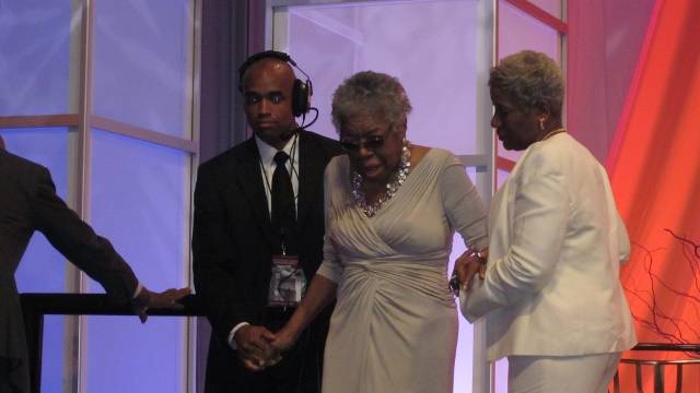 Dr. Angelou is escorted on stage to recite her poem at the Washington Convention Center on August 26, 2011 in Washington, DC.