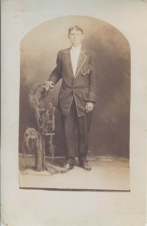 Grandfather in his dandy new suit he bought for his graduation from barber college.