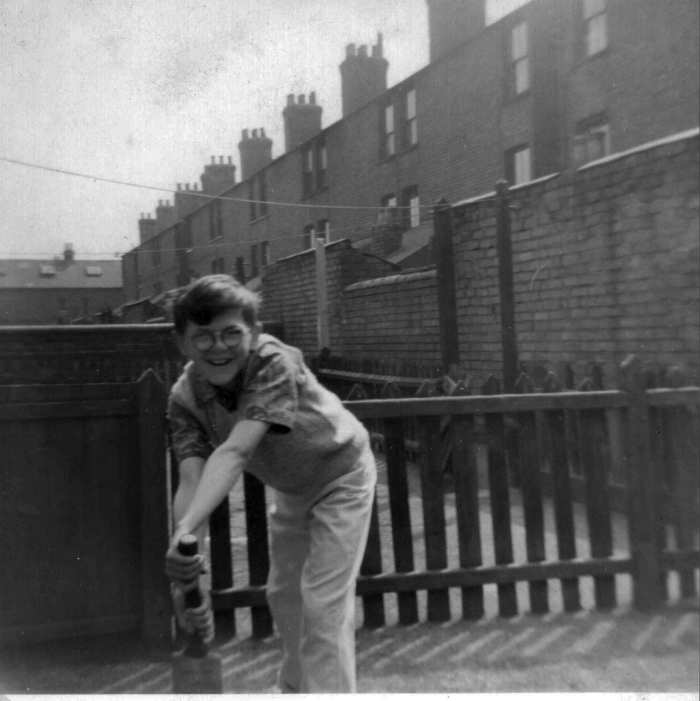 My brother in our back yard and behind him you can see the houses on the next street that backed onto ours. Just above his head you can see part of the washing line.
