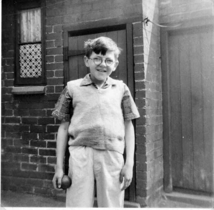 My brother much younger stood in front of our nextdoor neighbour's coal house and the outside toilet in our shared back yard.
