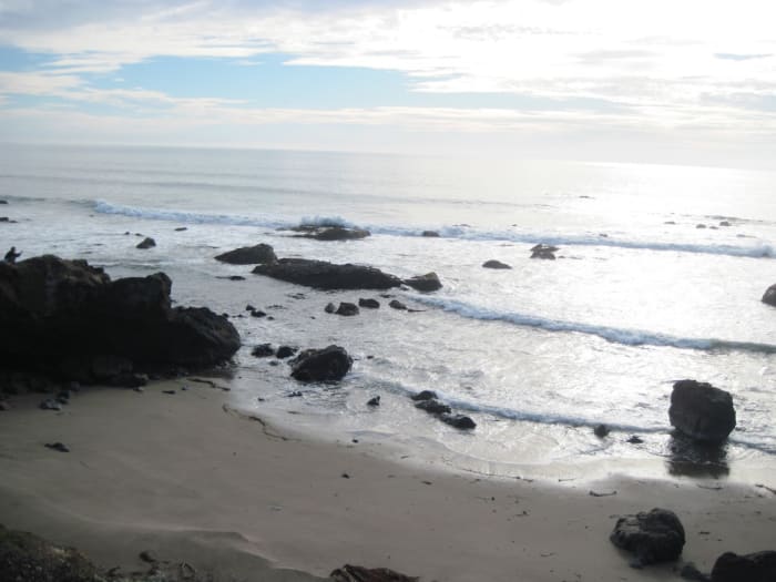 See the small man on the very left atop the rock? He watches the waves that that just keep coming, like his emotions, in waves of torment.