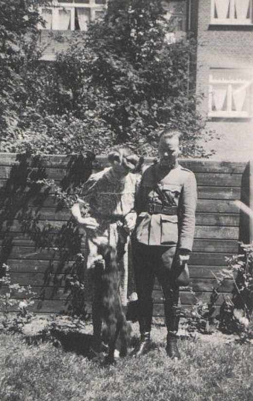 My dad in army uniform with my mom in their garden with the dog Omar, a wedding present from my dad to my mom.