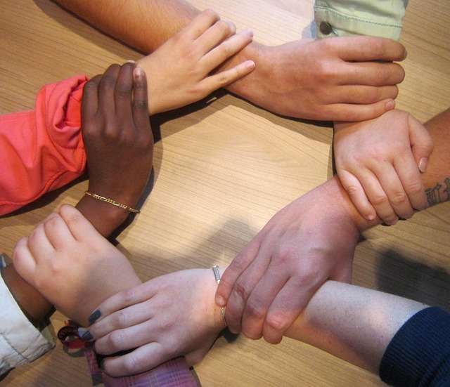 Hands are joined together, locked in love, symbolic of solidarity, diversity and acceptance.