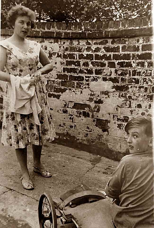 Mum and my brother Eric in the back yard of grandma's guesthouse in the late 1950s. My brother was getting his kart ready to use on the beach.