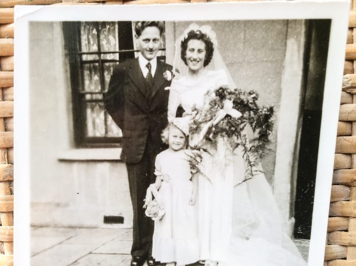My parents outside the house on Fleet Street on their wedding day. The bridesmaid is one of my cousins.