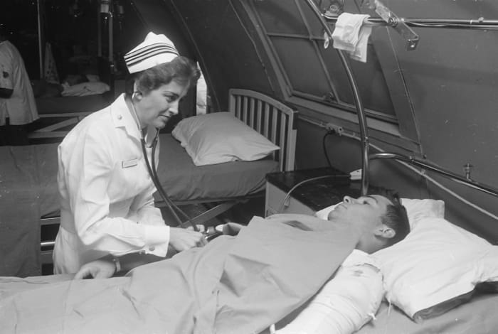 Lieutenant Commander Joan Brouilette with a patient at the hospital in Da Nang, South Vietnam, 1968.