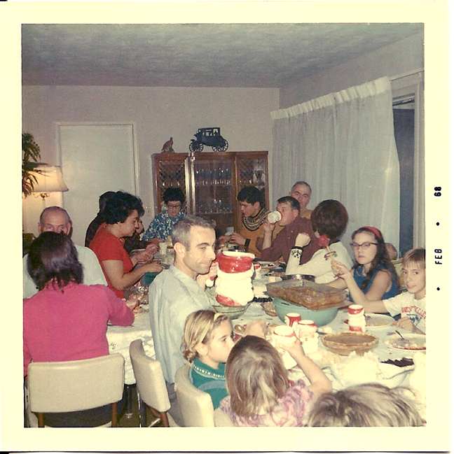 Christmas Dinner in the '60s. I'm the dark haired girl with the cat-eye glasses on the right.