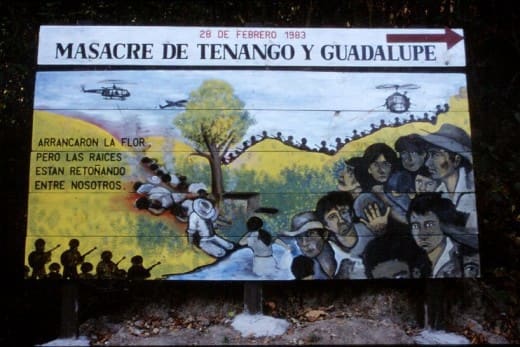 “A billboard serving as a reminder of one of many massacres that occurred during the Civil War in El Salvador. The Spanish inscription to the left reads in English: ‘They tore out the flower, however the roots are sprouting among us.’
