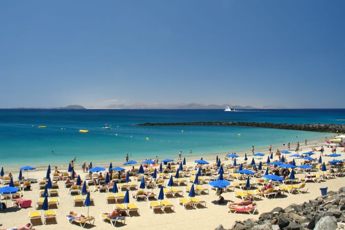Views across Atlantic Ocean to Island of Fuerteventura from Dorado beach in Playa Blanca.