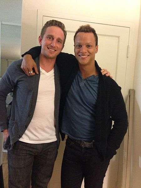 Two buddies wearing cardigan sweaters. Aren't you glad that American guys are free to wear sweaters in public, private, or any day of the week?