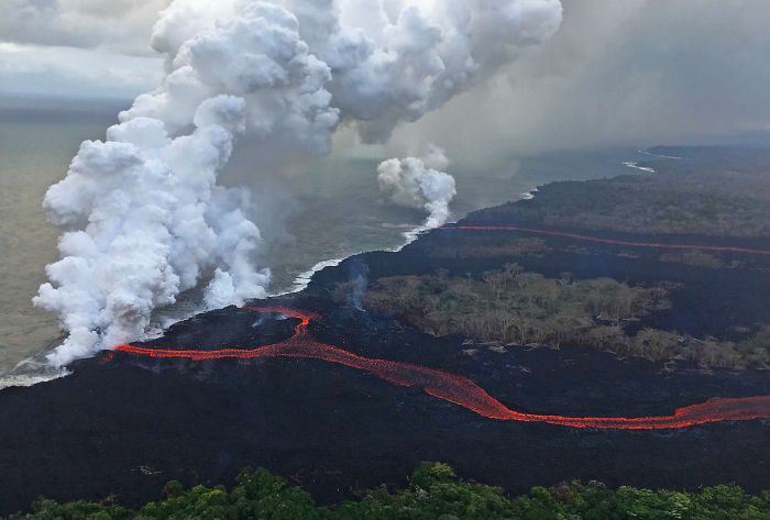 Lava enters the ocean creating plumes of laze along Puna coastline. (Photo courtesy of USGS-HVO)