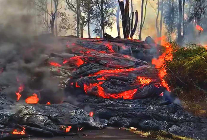 A wall of lava comes down a residential street. (Photo courtesy of USGS-HVO)