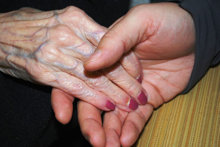 Raymond sat in a chair on the other side of the bed, holding his mother's other hand. "I love you Ma, so much."