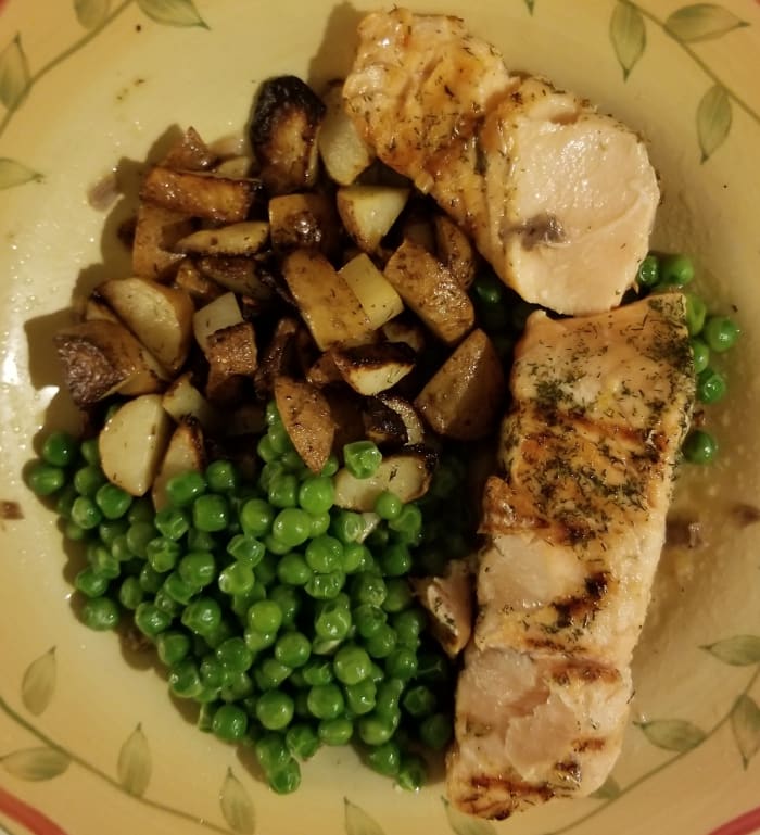 Grilled salmon and potatoes with lemon and dill with a side of buttery peas