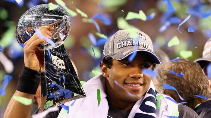 Russell Wilson hoists the Lombardi Trophy after his Super Bowl XLVIII victory. 