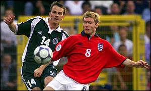 Germany's Dietmar Hamann (14) and England's Paul Scholes (8) battle for possession during a Euro 2000 match in Charleroi, Belgium. England won the match 1-0, but both nations exited the group stage in that tournament.