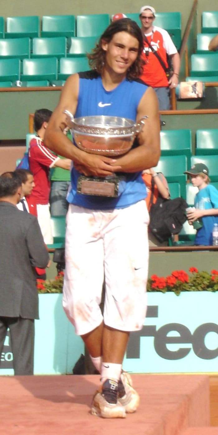 Rafael Nadal, seen here after winning the 2006 French Open tournament, has won the tournament a record nine times, including an Open Era record of five consecutive titles.