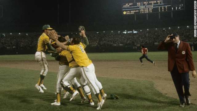 A's celebrate their third straight World Series Championship as umpire Ron Luciano tries to get off the field.