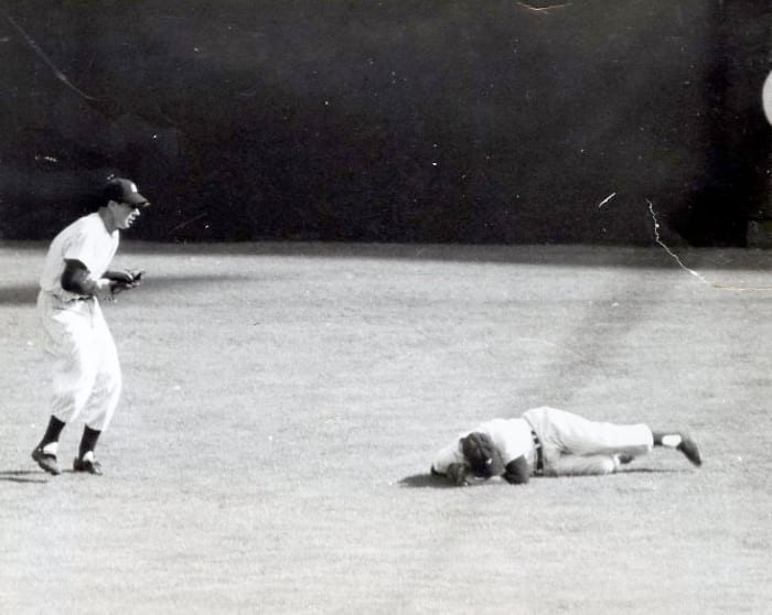 Game 2, 1951 World Series: Dimaggio catches Mays' fly ball as Mantle sustains the first of many knee injuries.