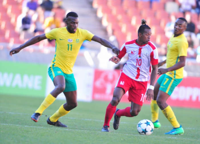 Madagascar's Andriamirado Hasina (#10) battles for possession with South Africa's Matlhari Makaringe (#11) during a 2018 COSAFA Cup quarterfinal in Polokwane, South Africa. Madagascar eliminated the hosts on a penalty shootout.