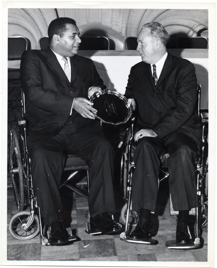 Former Dodgers Hall of Famer Roy Campanella (left) shares a moment with former Boston Mayor John F. Collins. Campanella was forced into a wheelchair after an automobile accident prematurely ended his baseball career.