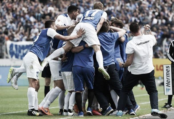 Hanno Behrens (#17) jumps onto a pile of personnel during SV Darmstadt 98's match against FC St. Pauli on May 24, 2015. The 1-0 victory secured the club's return to Bundesliga after a 33-year absence.
