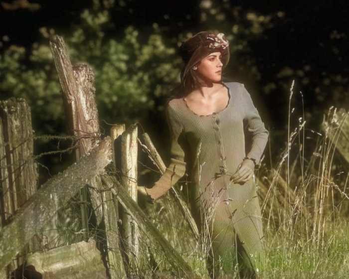 The green of the foliage seems to be seeping into this model's dress, turning it a lovely shade of greenish gray.