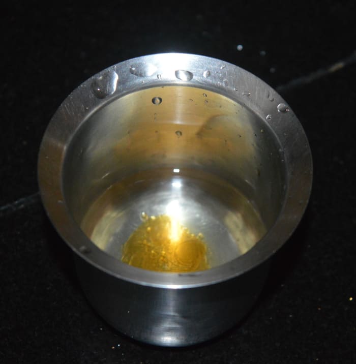 To check the consistency, add a few drops of the boiling jaggery syrup in the water. If you can gather the jaggery and form a ball, this is the right consistency.