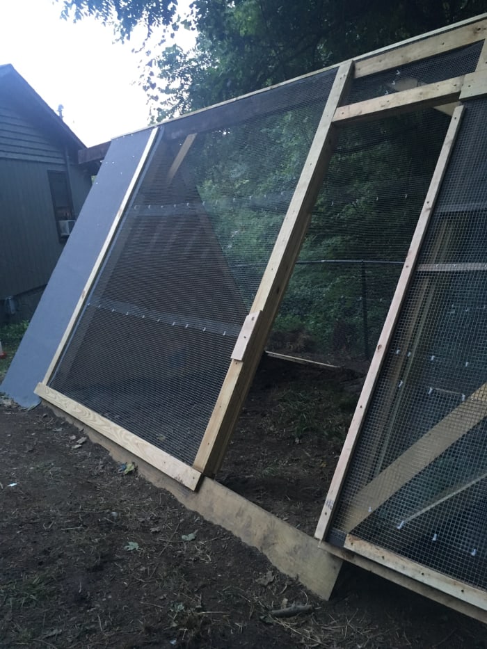 I rolled hardware cloth out in rows and attached them together with zip ties. I also secured the edges of the hardware cloth to the pen with 2x4s. A roll of roofing was put over the "A" shaped house roof.