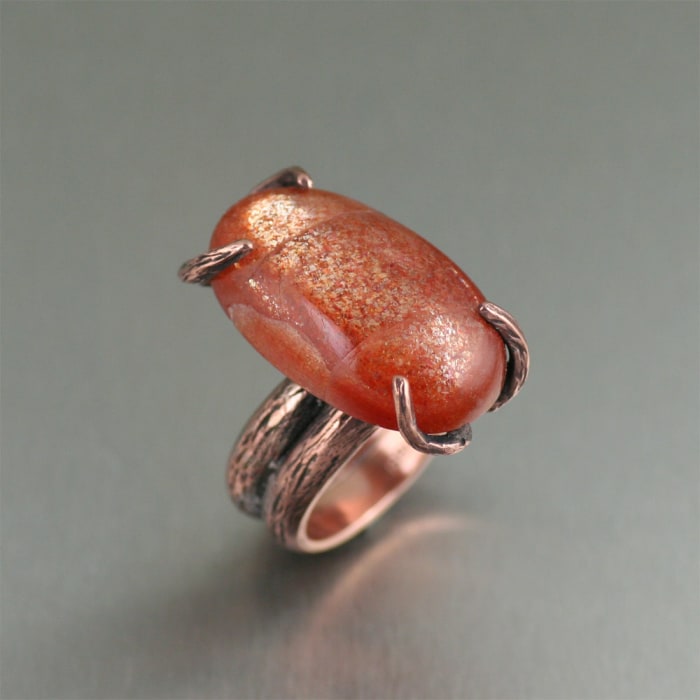 Uncover uncommon luxury in this Copper Bark Sunstone Handmade Ring. The nature-inspired, handcrafted branch texture is highlighted with a rich orange colored 29 carat Sunstone cabochon.