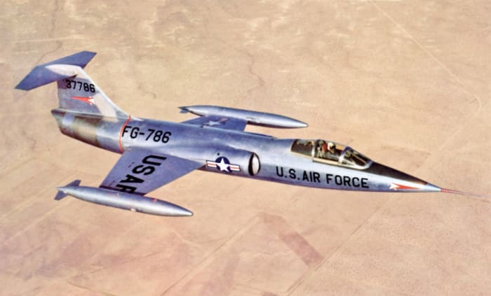 The F-104 Starfighter was the first combat aircraft capable of a sustained air speed of Mach 2 . The F-104 was the first aircraft to simultaneously hold the world speed (1,404 mph) and altitude records (103,3089 ft.).