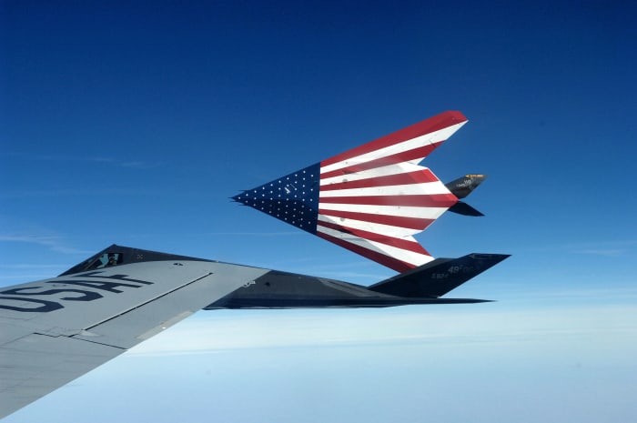 Two F117s on the way to an airshow with the American flag painted on the bottom of the aircraft.