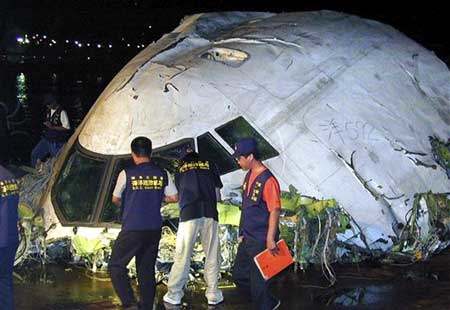 In this June 23, 2002 file image, Taiwan coast guard inspect the cockpit of the China Airlines Boeing 747-200 flight 611 recovered from the Taiwan Strait on the outlying Taiwan island of Penghu, on the main island of Penghu, Taiwan.