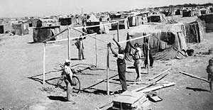 Shack-dwellers building their sack hovels which James Mpanza fought against and got them half-way decent housing