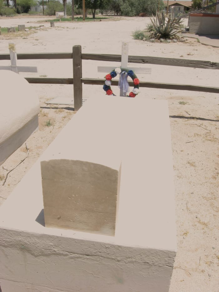 Tomb of WWI hero Mathew Juan. Cross at end with recently placed wreath shows that he is still remembered today.