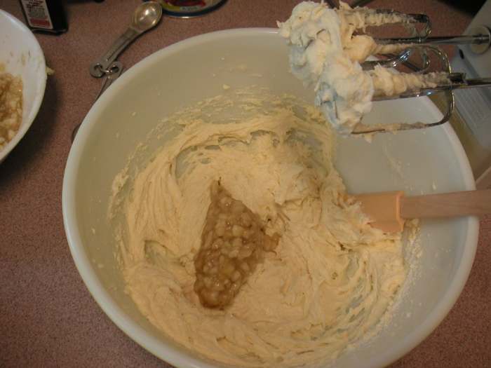 Alternate adding the dry and wet ingredients while mixing. Add the chopped nuts last stirring in by hand.