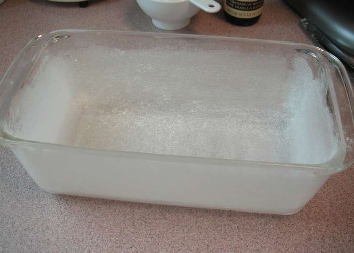 Sprinkle a dusting of flour over the greased pan and distribute the flour evenly shaking out the excess.