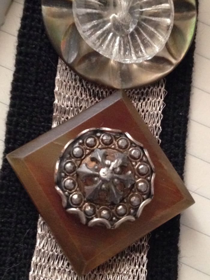 Celluloid buttons are gorgeous. They were often used for coats. Stacked button creations are a fun and easy way to showcase your favorite buttons. Here, I stitched the buttons to a wide piece of black elastic for a cuff bracelet I created.
