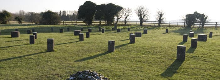 Woodhenge: a Neolithic monument, dating from about 2300 BC, with concrete markers replacing six concentric rings of timber posts, once possibly supporting a ring-shaped building.